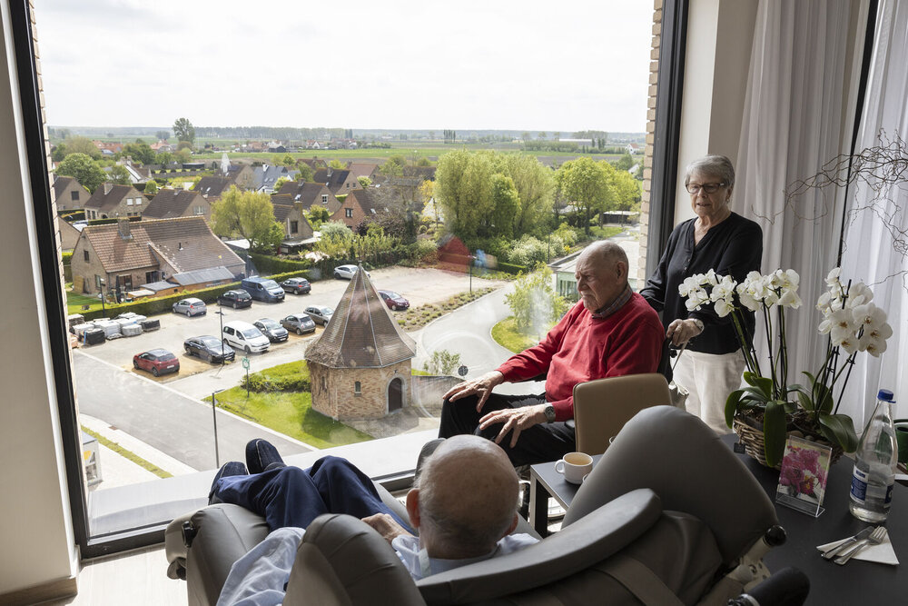 Bewoners in een woonzorgcentrum genieten van het uitzicht op de kerk.