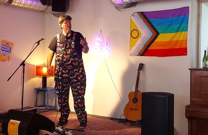 Persoon naast de LGBTI+ vlag