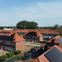 bovenaanzicht van de wijk met de daken met zonnepanelen