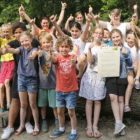 20-tal enthousiaste kinderen met de duim omhoog