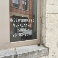 foto voorgevel met tekst 'onbewoonbaar verklaard'
